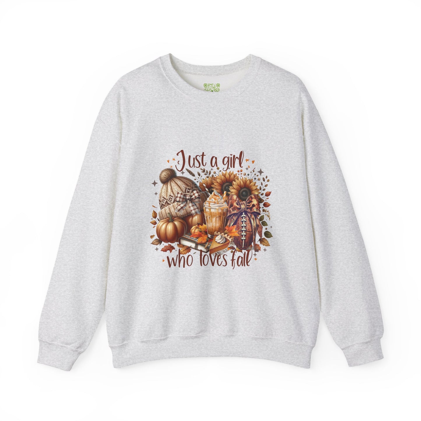 Woman wearing a cozy white sweatshirt with autumn-themed graphic saying 'Just a girl who loves fall'.