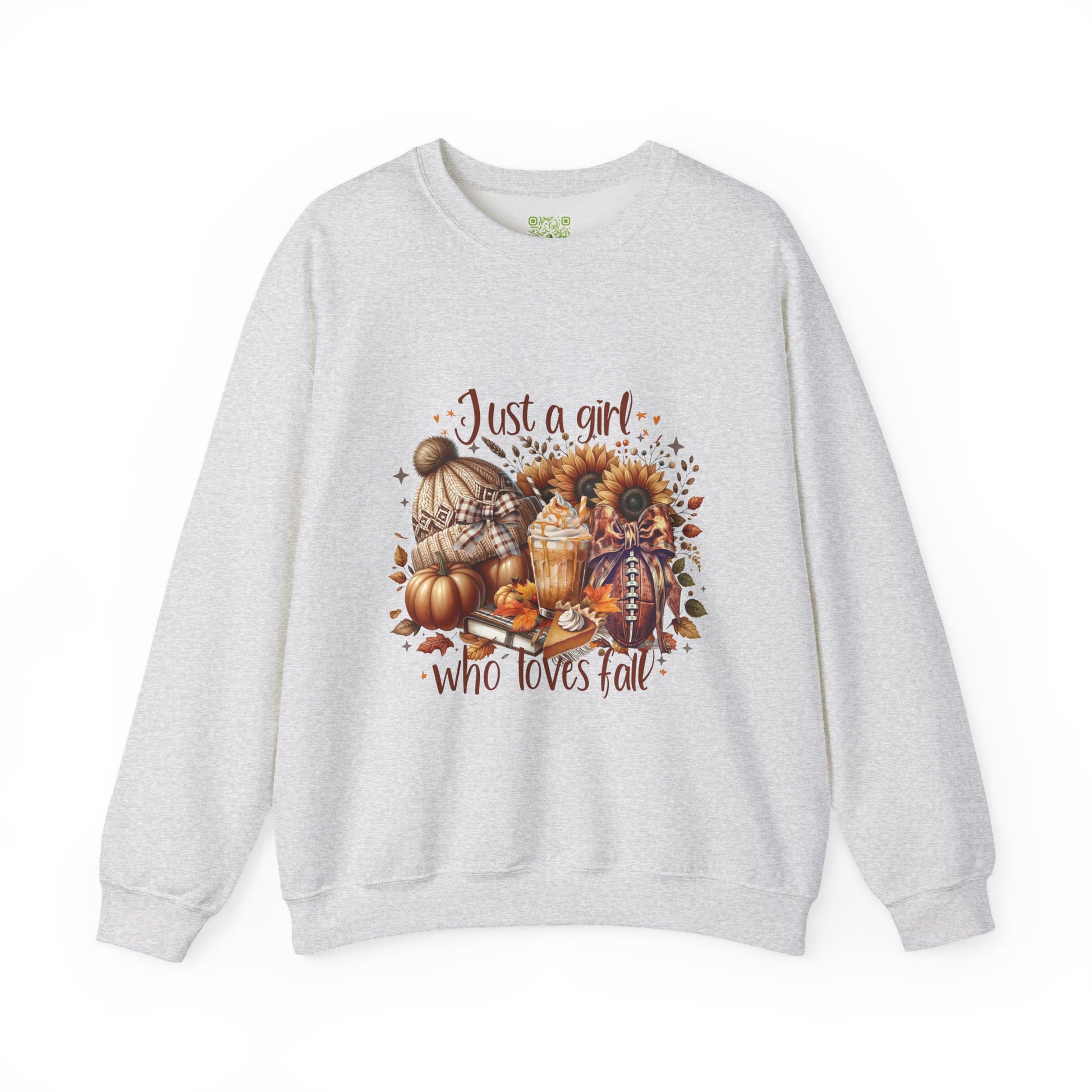 Woman wearing a cozy white sweatshirt with autumn-themed graphic saying 'Just a girl who loves fall'.